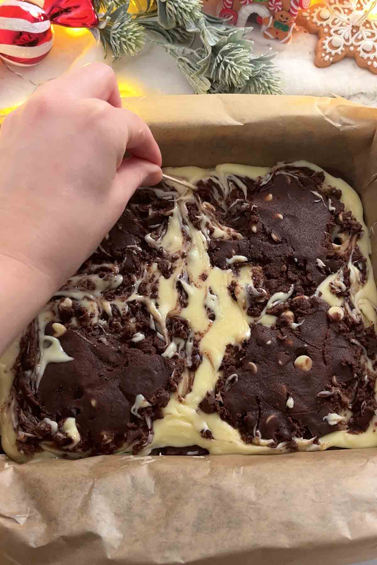 swirling the fudge and chocolate cookie dough together