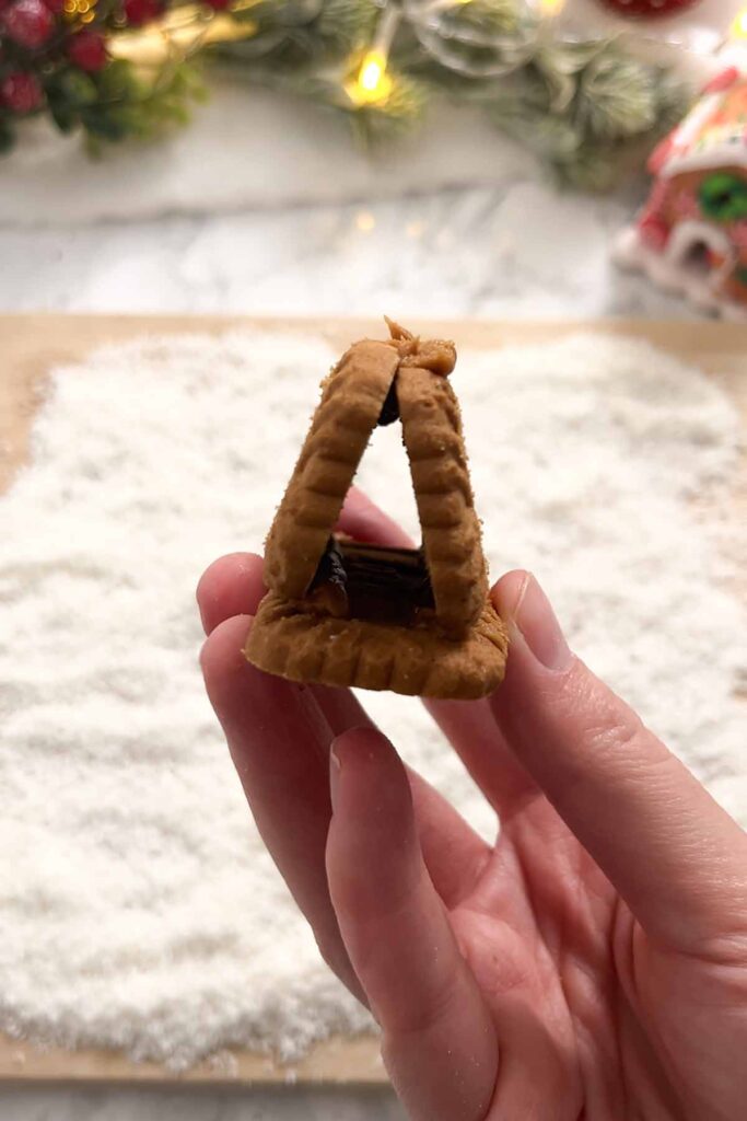 biscuit gingerbread house stuck together with biscoff spread