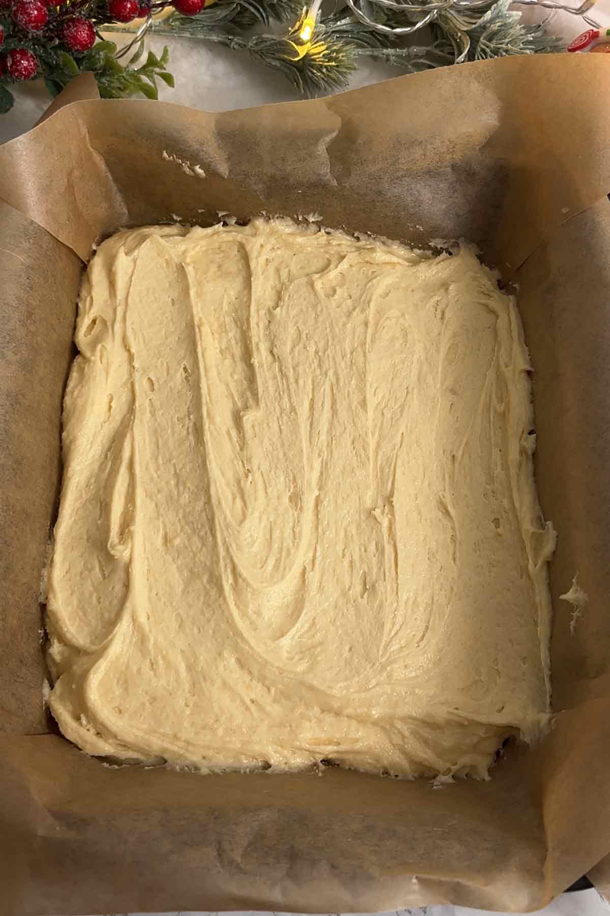 cake batter in a lined tin