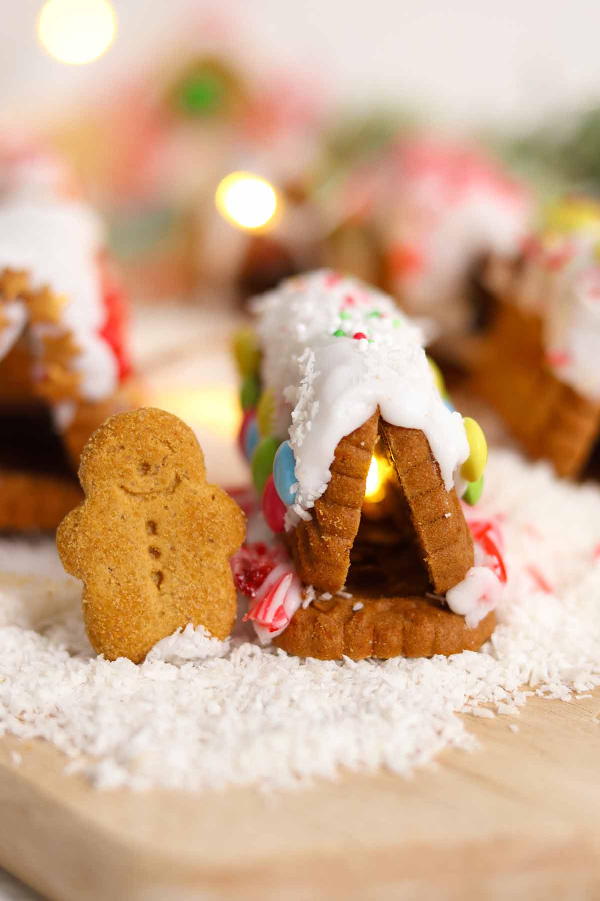 mini gingerbread man in front of biscoff gingerbread house village