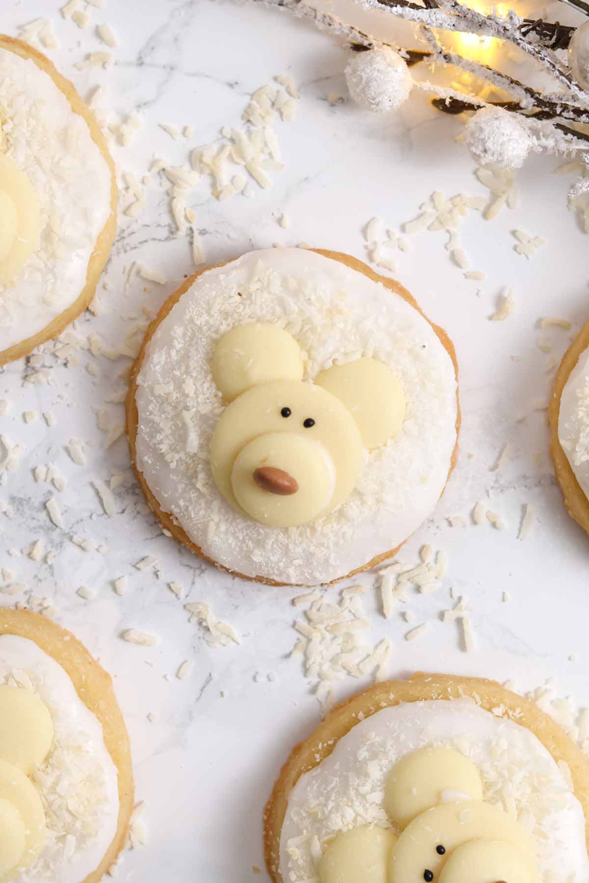 overhead image of christmas polar bear cookies on a white surface