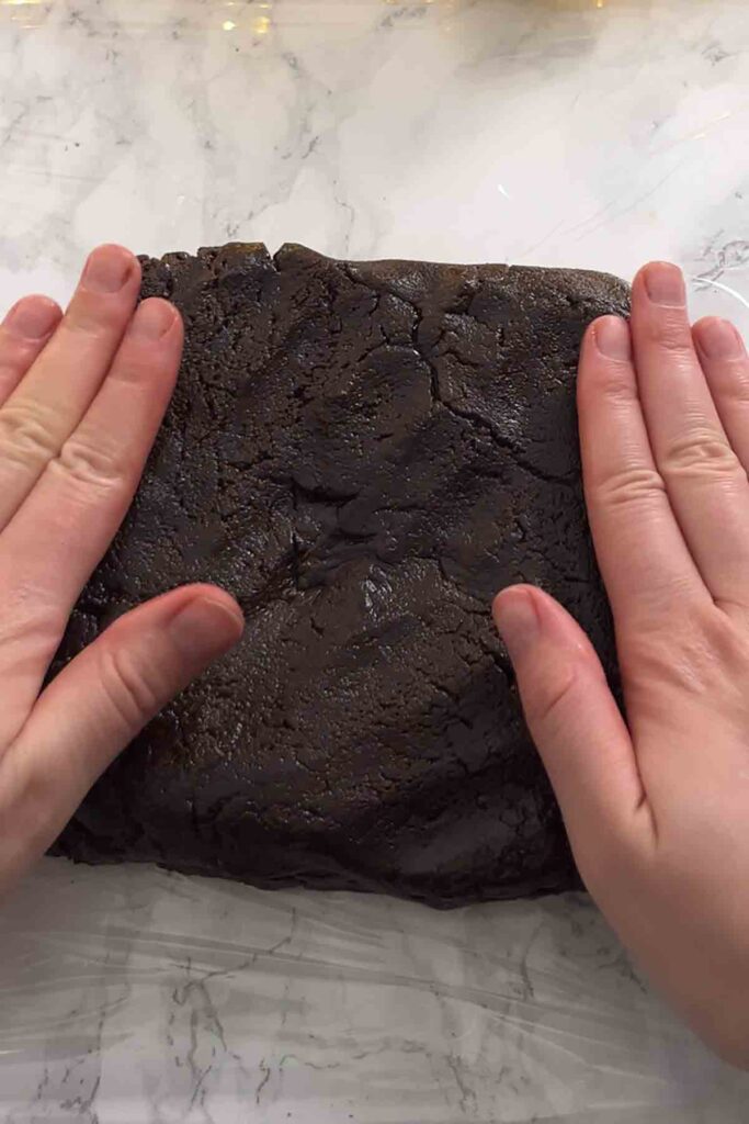 shaping the biscuit mixture into a rectangle with hands