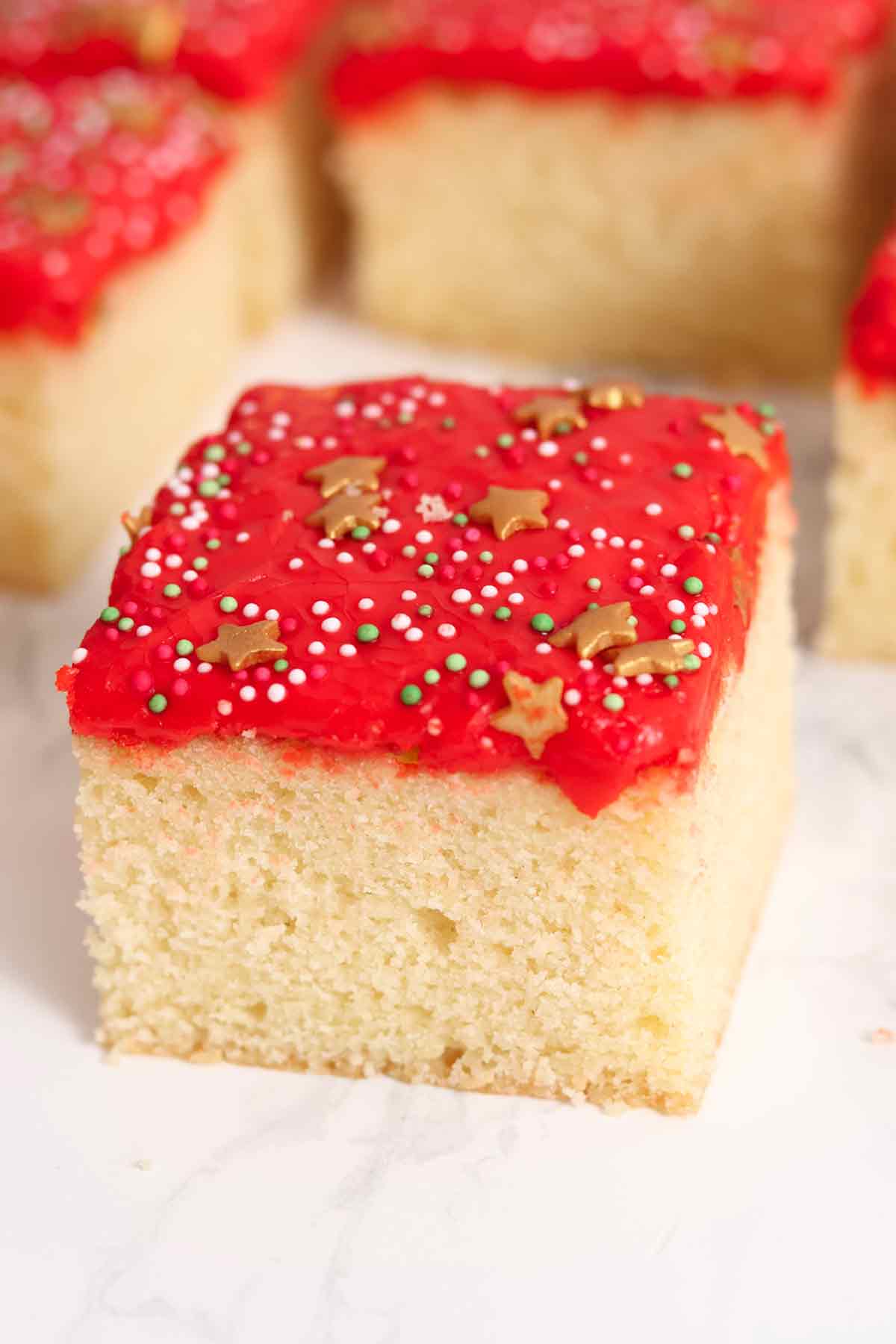 slices of christmas traybake cake on a white worktop