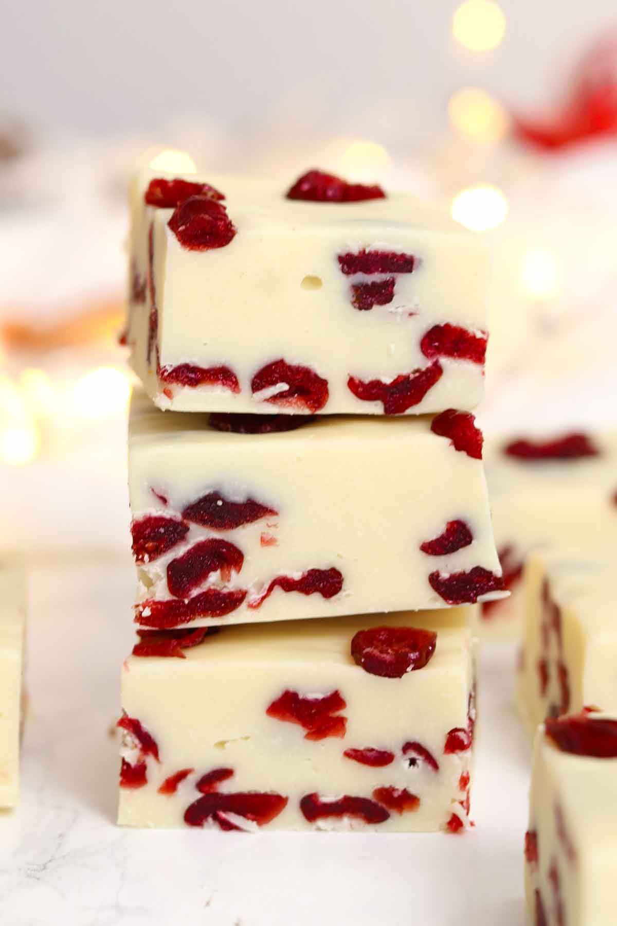stack of 3 pieces of white chocolate cranberry fudge