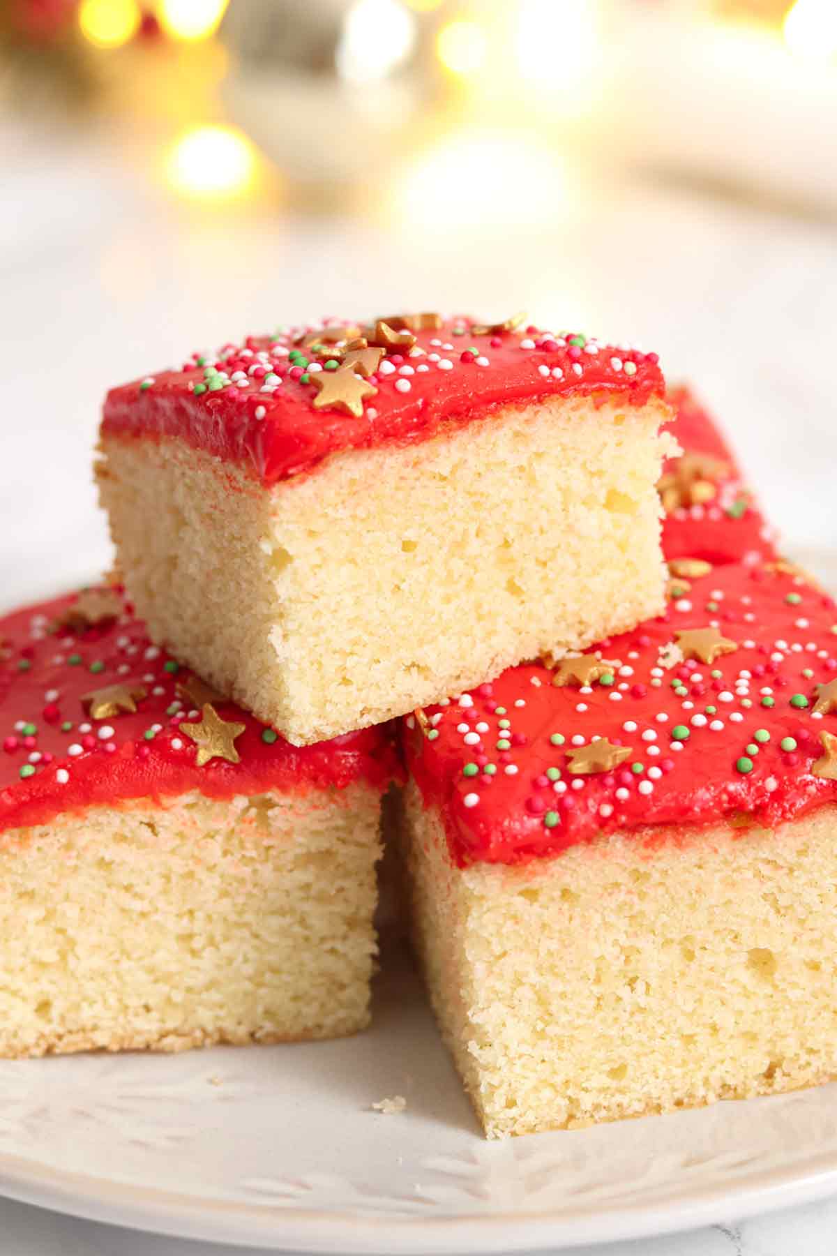 stack of christmas traybake cake slices on a plate
