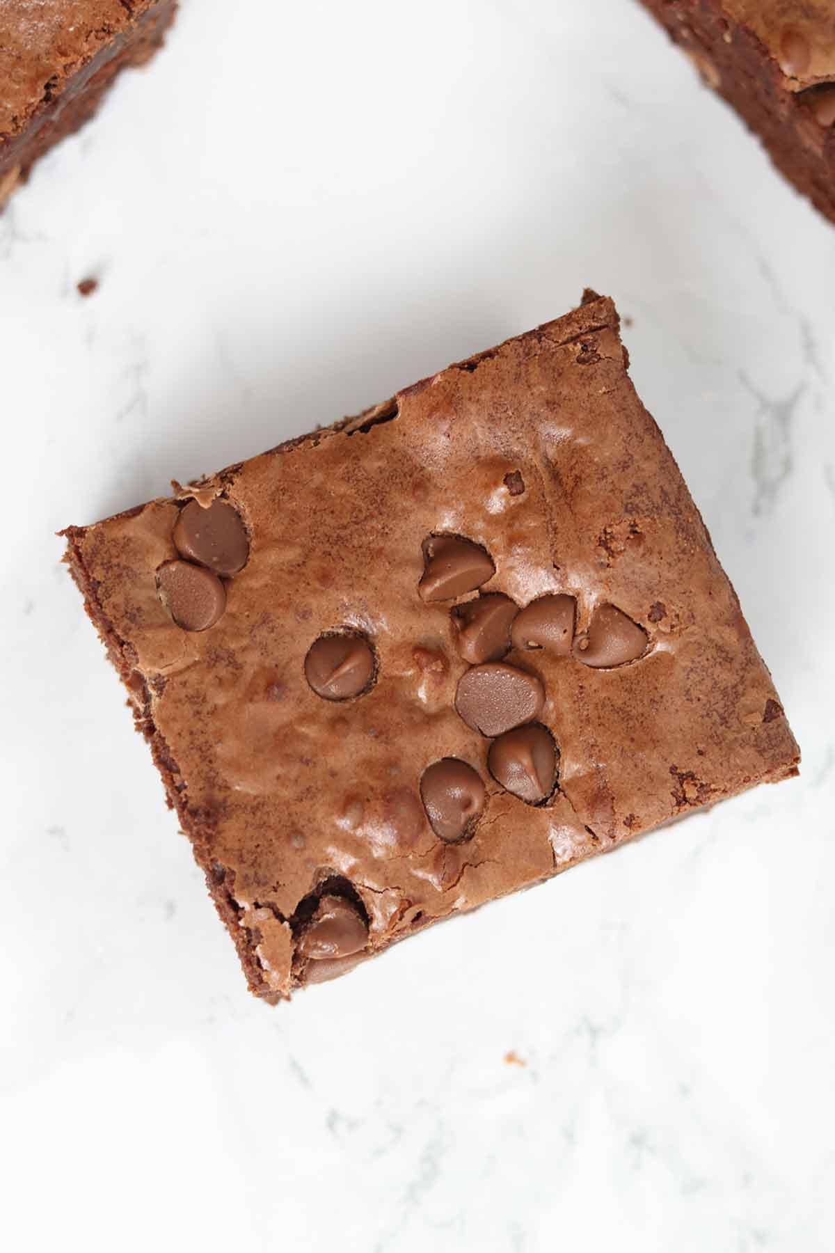 overhead image of brown sugar brownies with milk chocolate chips on top