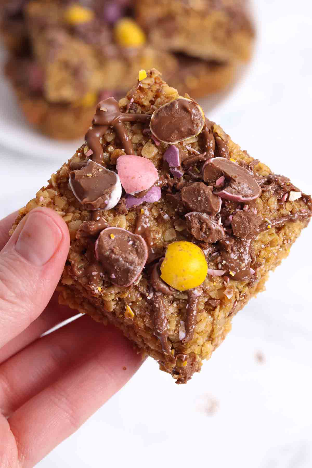 hand holding an easter mini egg flapjack square