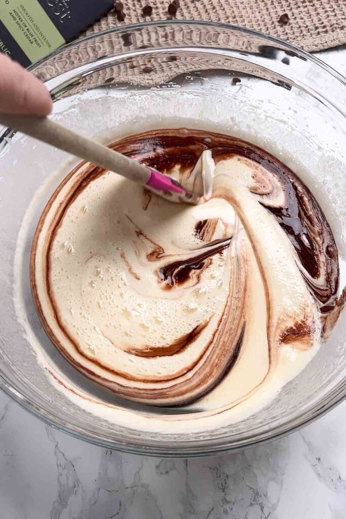 swirling chocolate and egg mix together