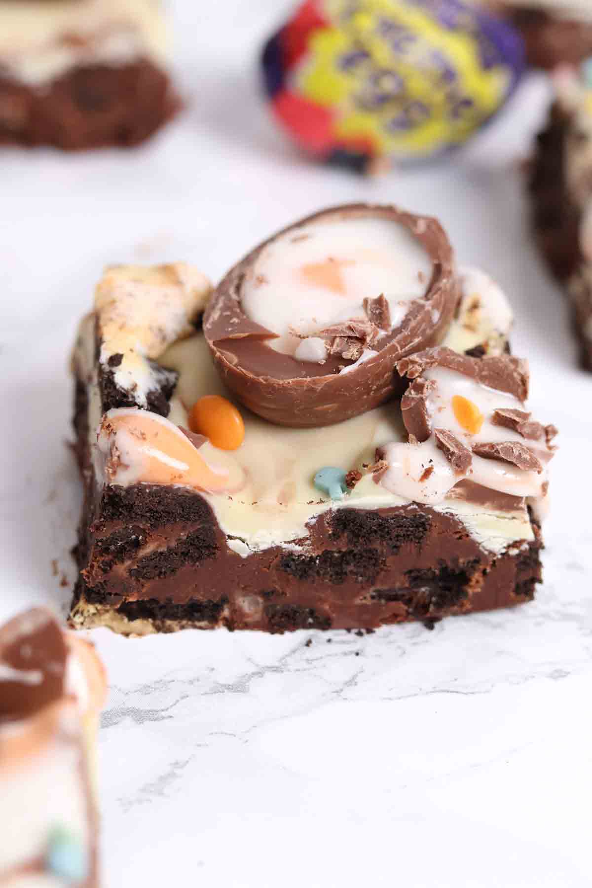 bars of creme egg traybake tiffin on a white surface
