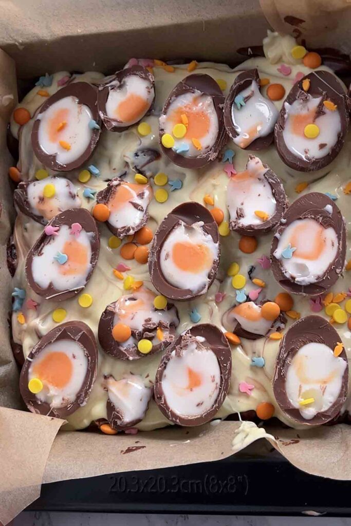 top of the tiffin decorated with creme eggs and easter sprinkles