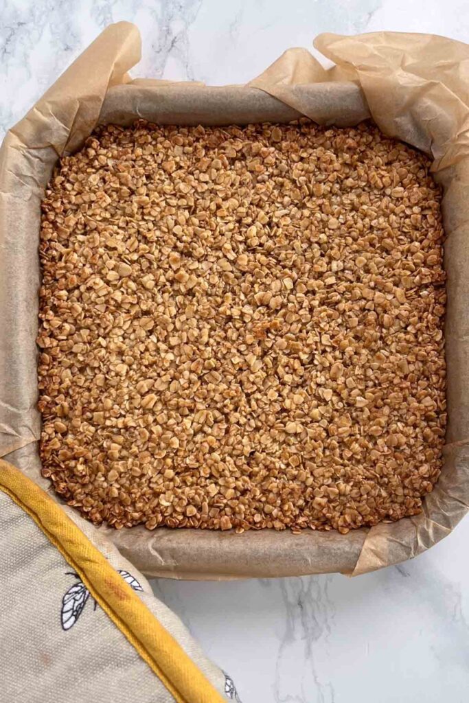 dairy free flapjack mixture in a lined tin