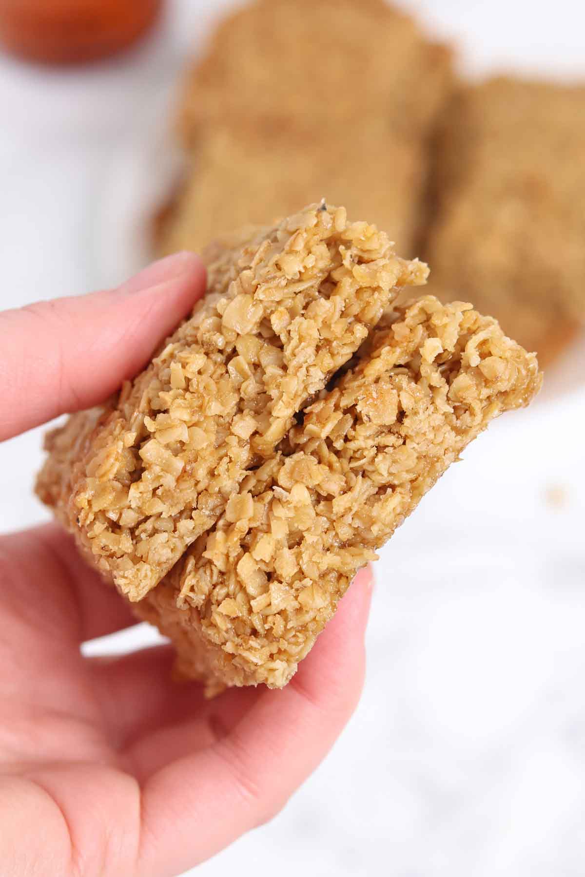hand holding up 2 vegan flapjacks