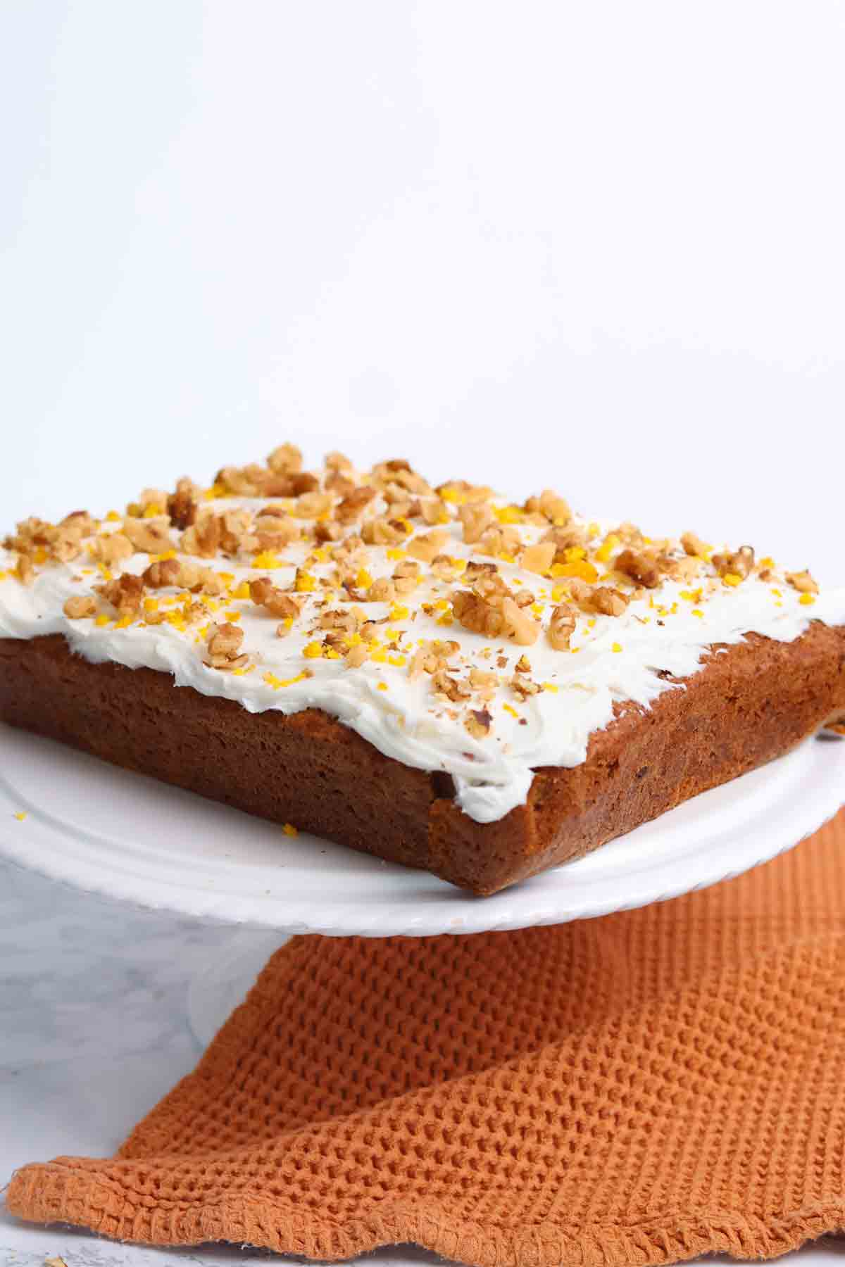 image of carrot cake traybake on a white cake stand