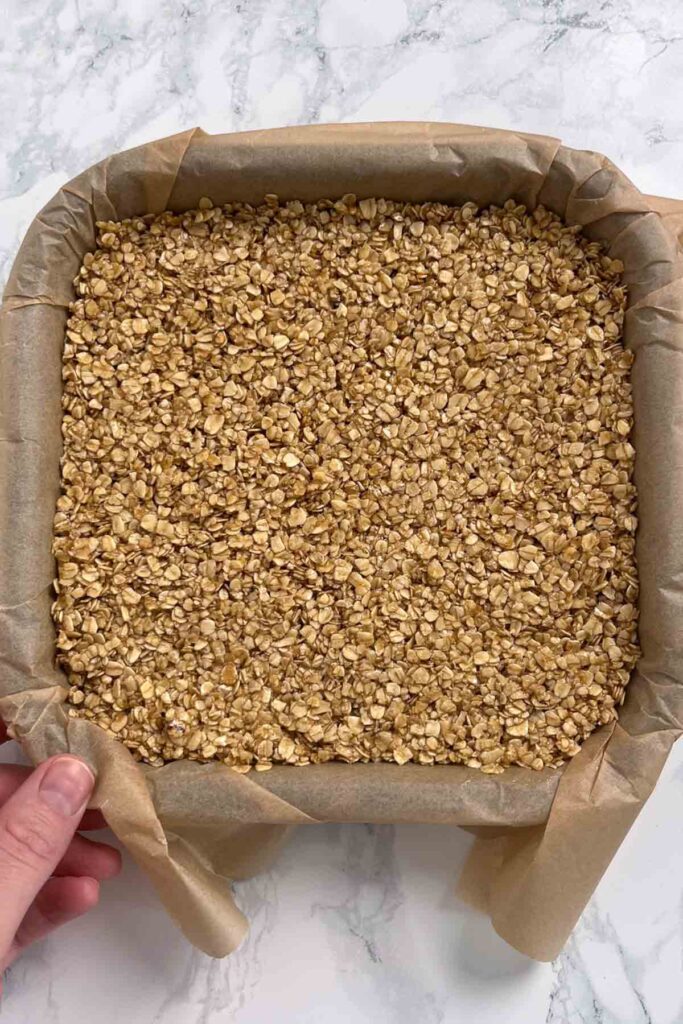 oat bar mixture pressed into square tin