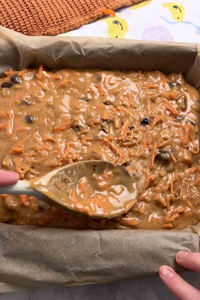 spreading batter into lined tin