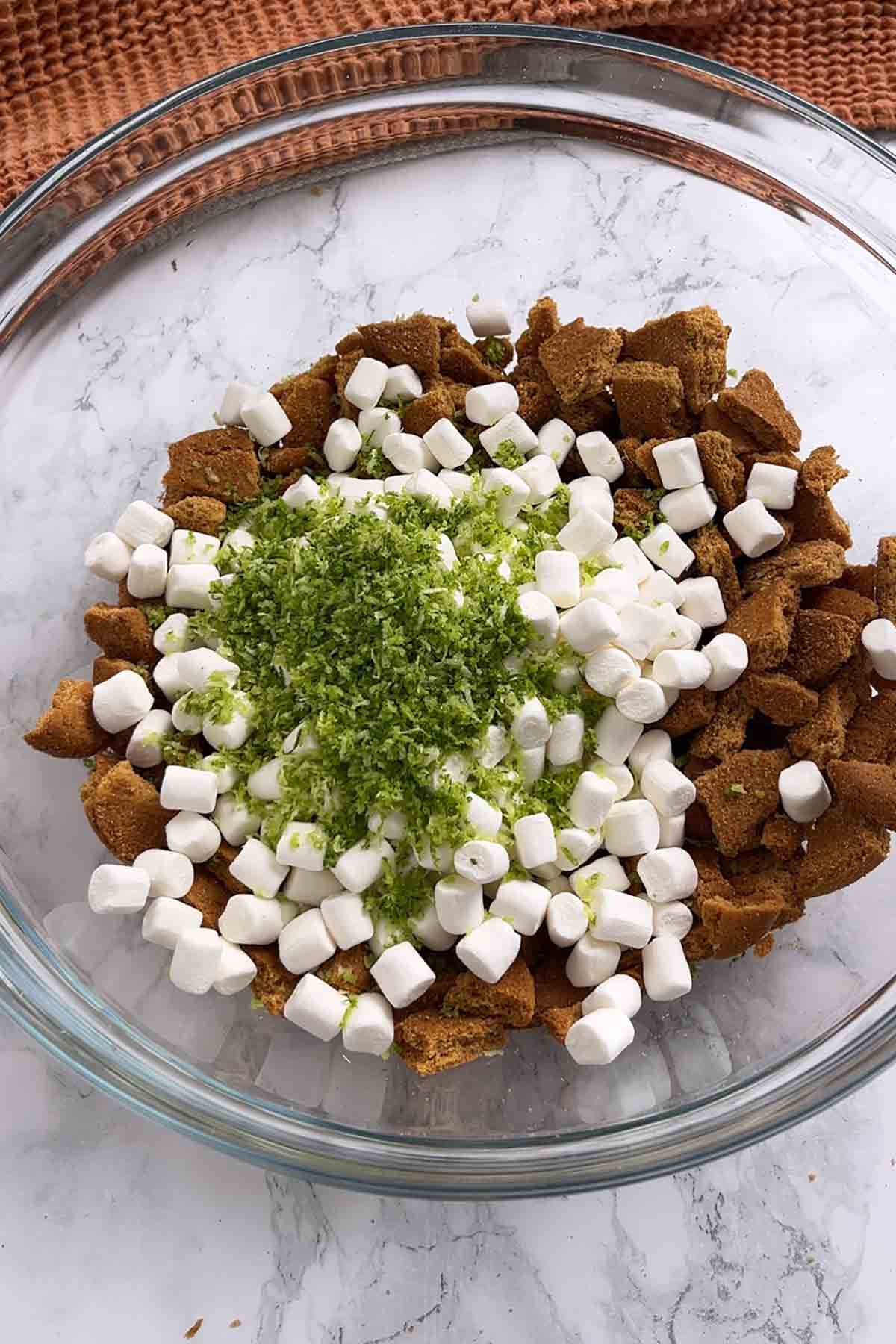 crushed gingernut biscuits marshmallows and lime zest in a bowl