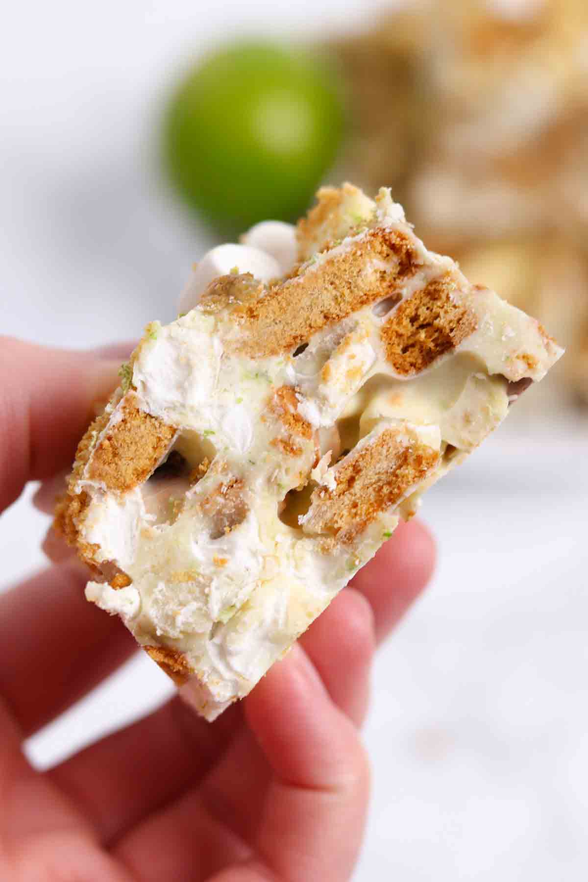 hand holding a slice of ginger and lime rocky road