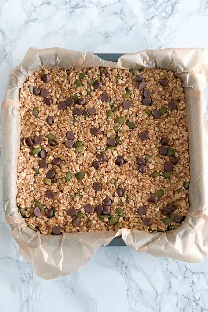 oaty mixture pressed into a lined square tin