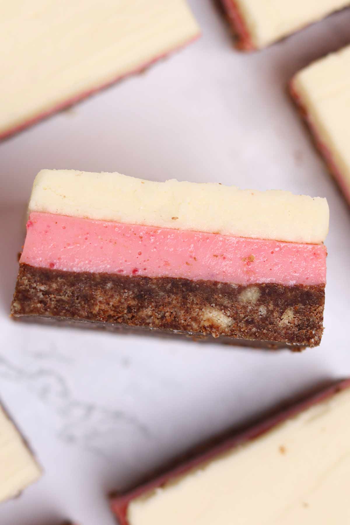 overhead image of neapolitan traybake squares on a white worktop