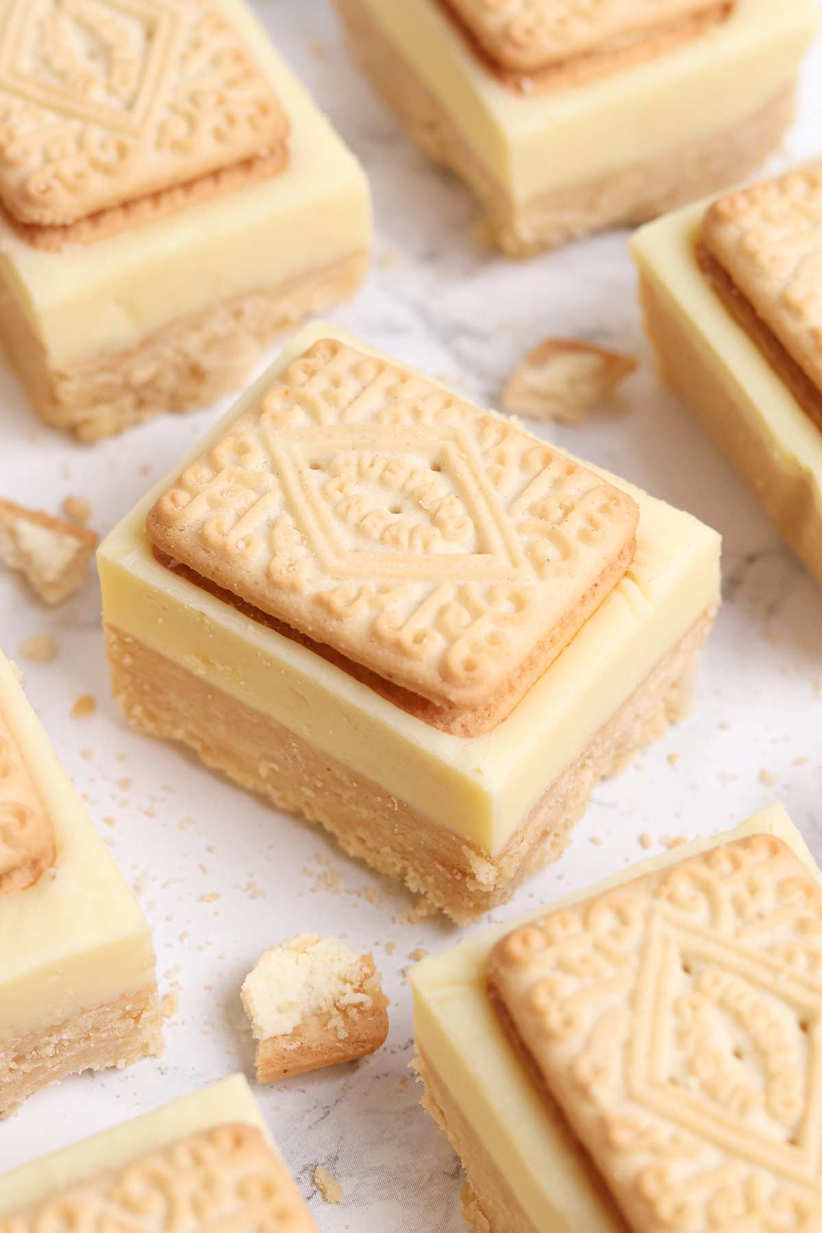 slices of no bake custard cream biscuit traybake on a white worktop