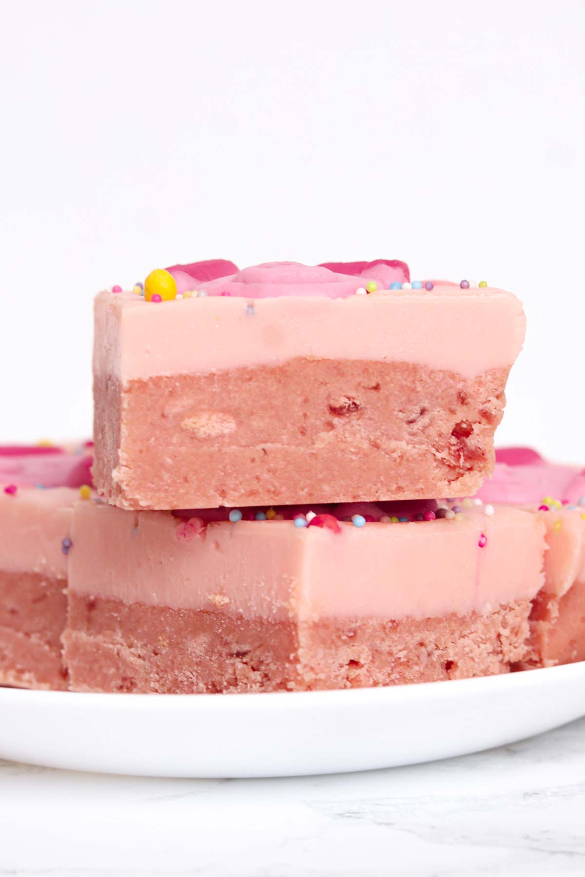 slices of no bake percy pig traybake bars on a white plate