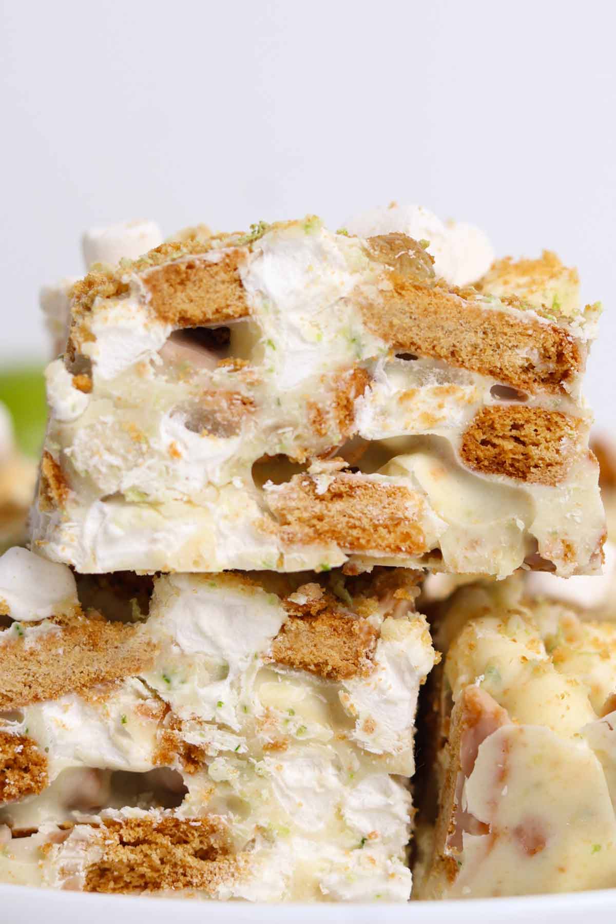stack of lime and ginger rocky road bars on a white plate