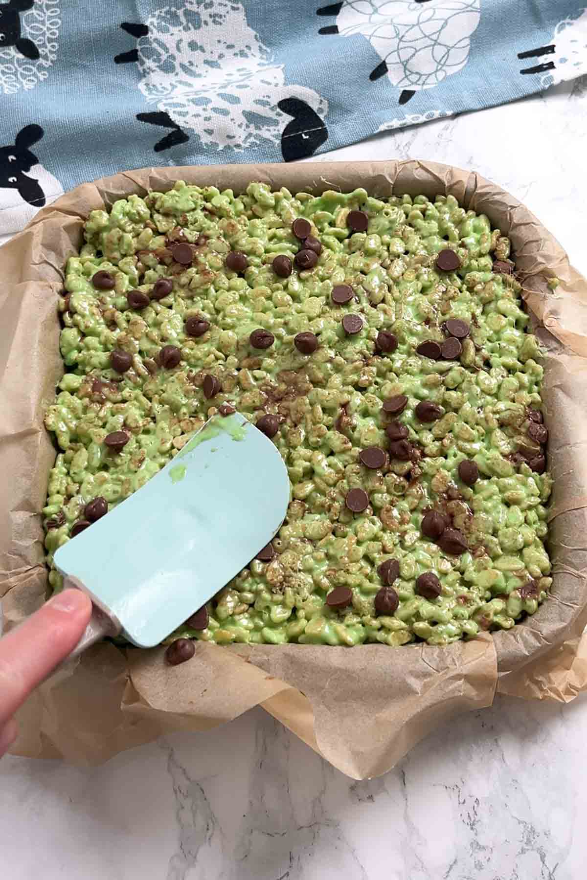 pressing the choc chip mixture into the lined pan