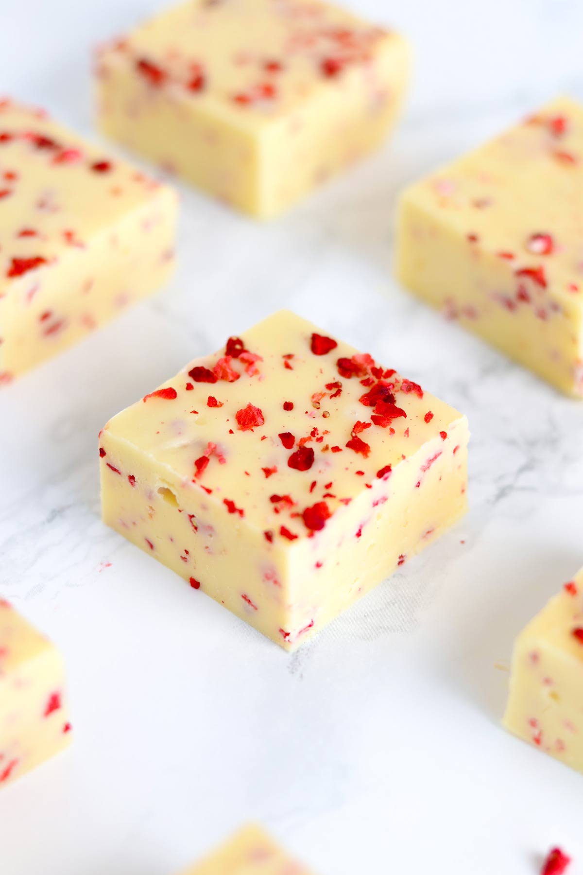 slices of strawberry lemon fudge on a white surface