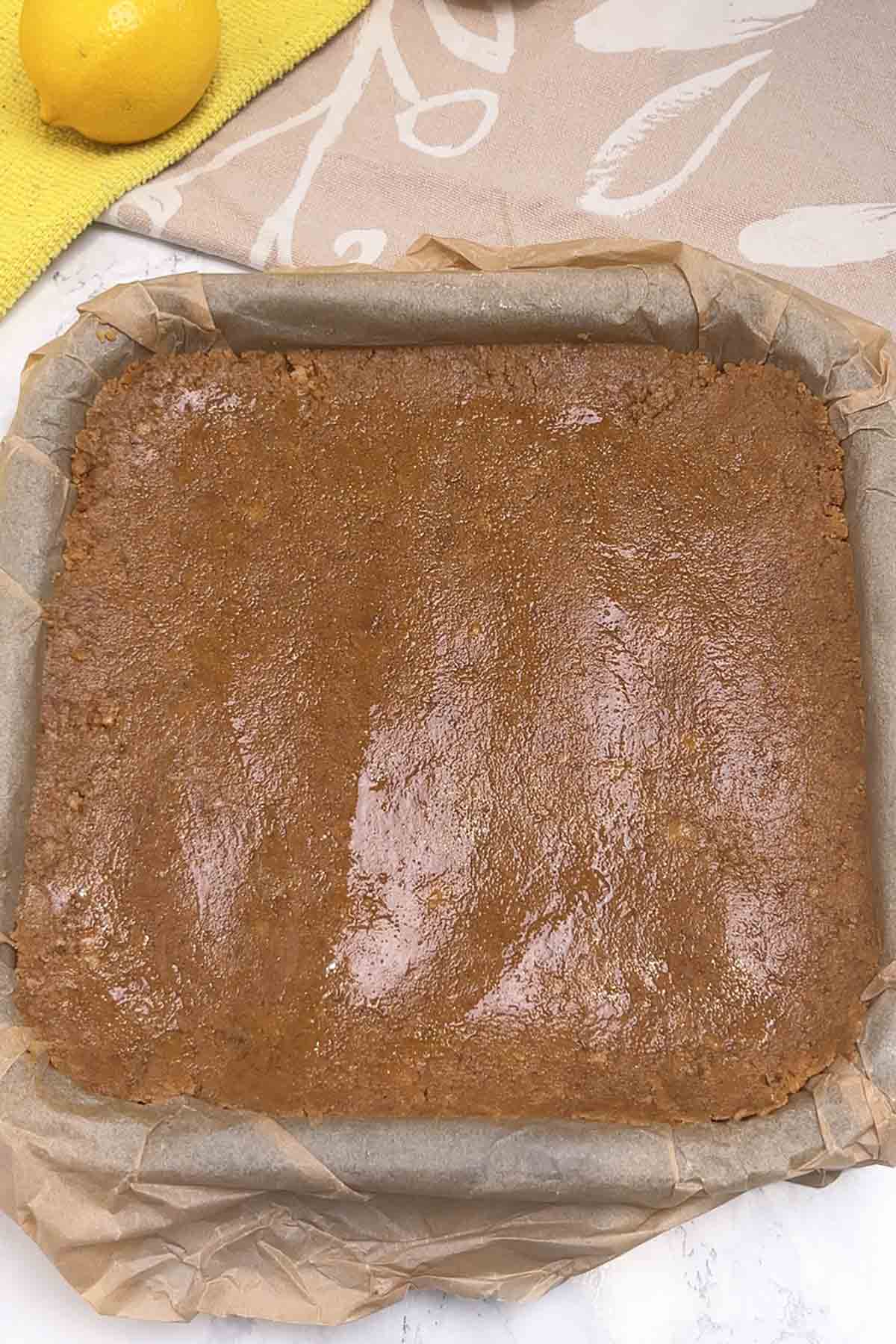 biscuit base pressed into lined tin