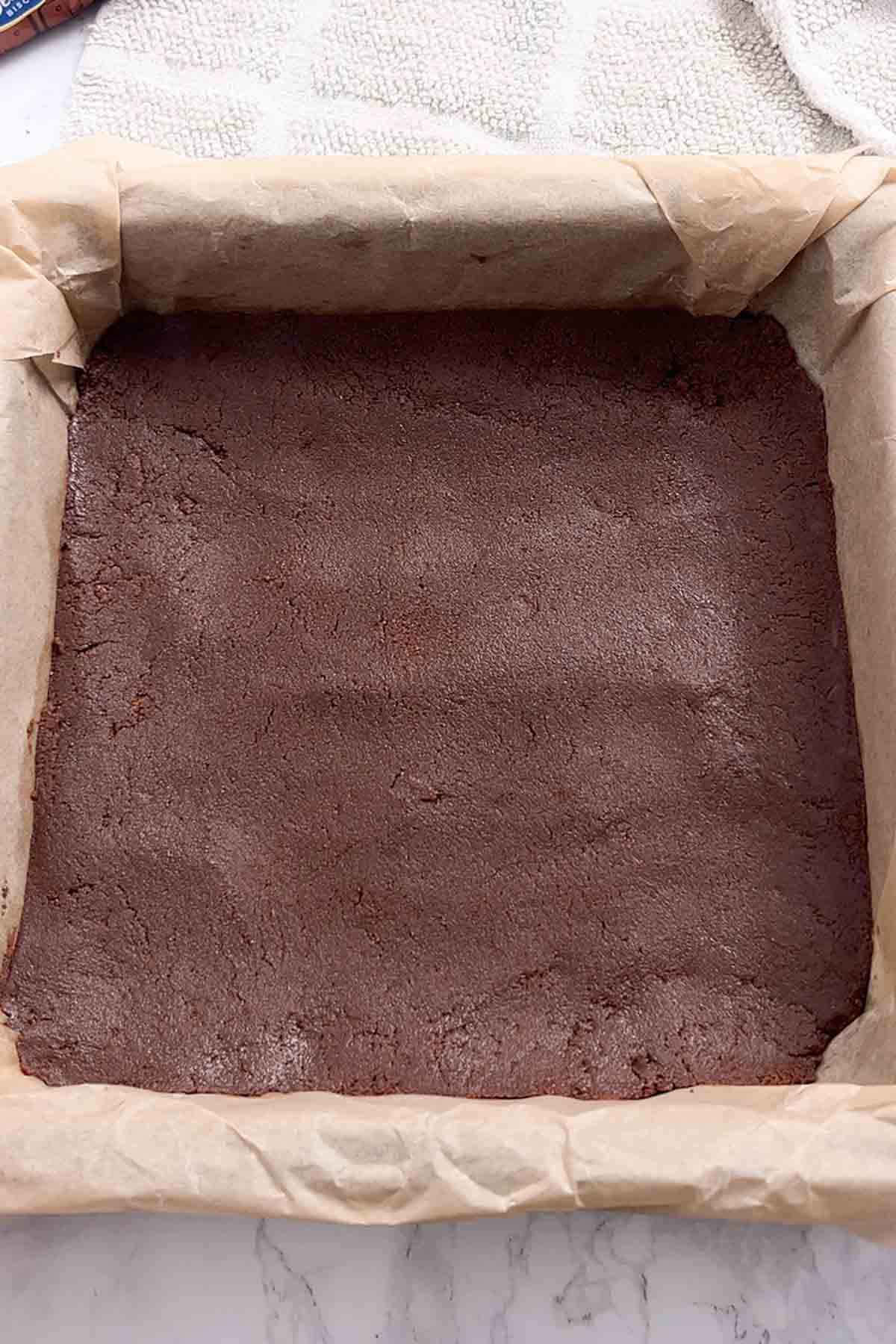 chocolate biscuit base pressed into lined tin