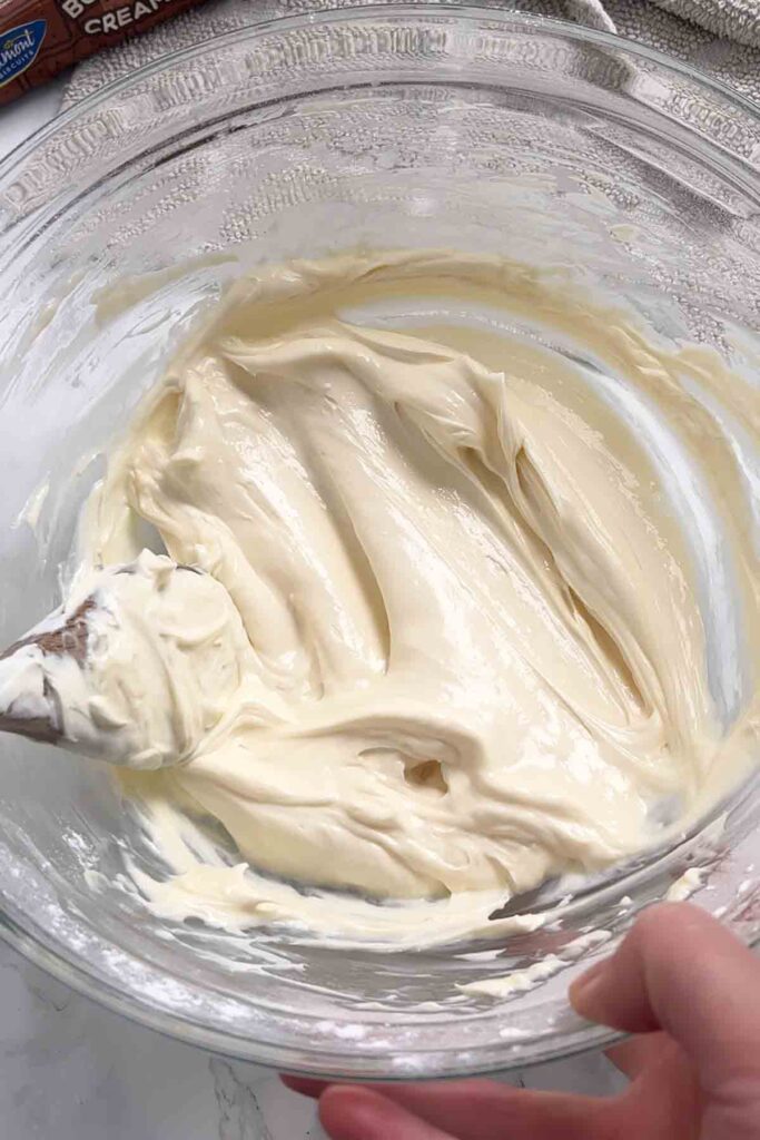 cream cheese and icing sugar mixed together in a bowl