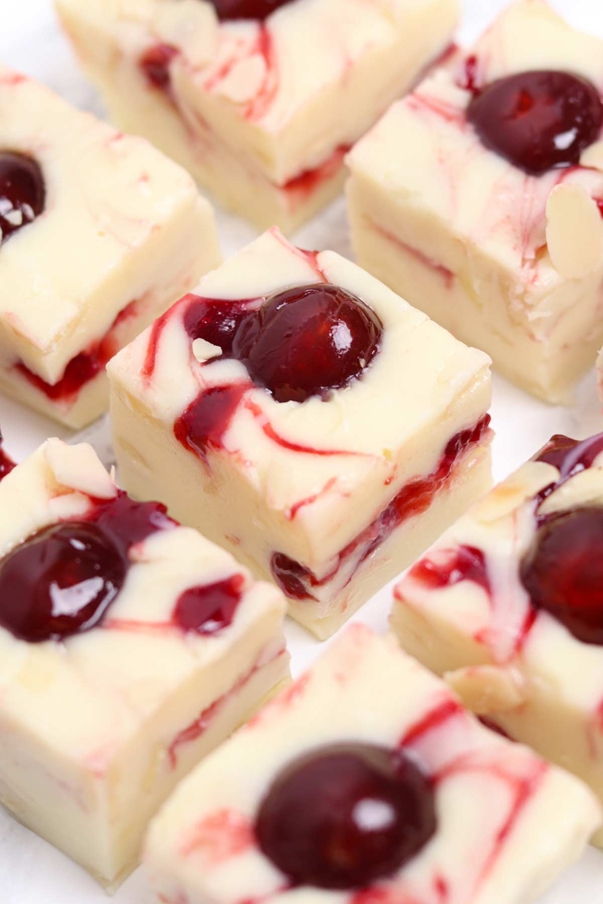 squares of cherry bakewell fudge on a worktop