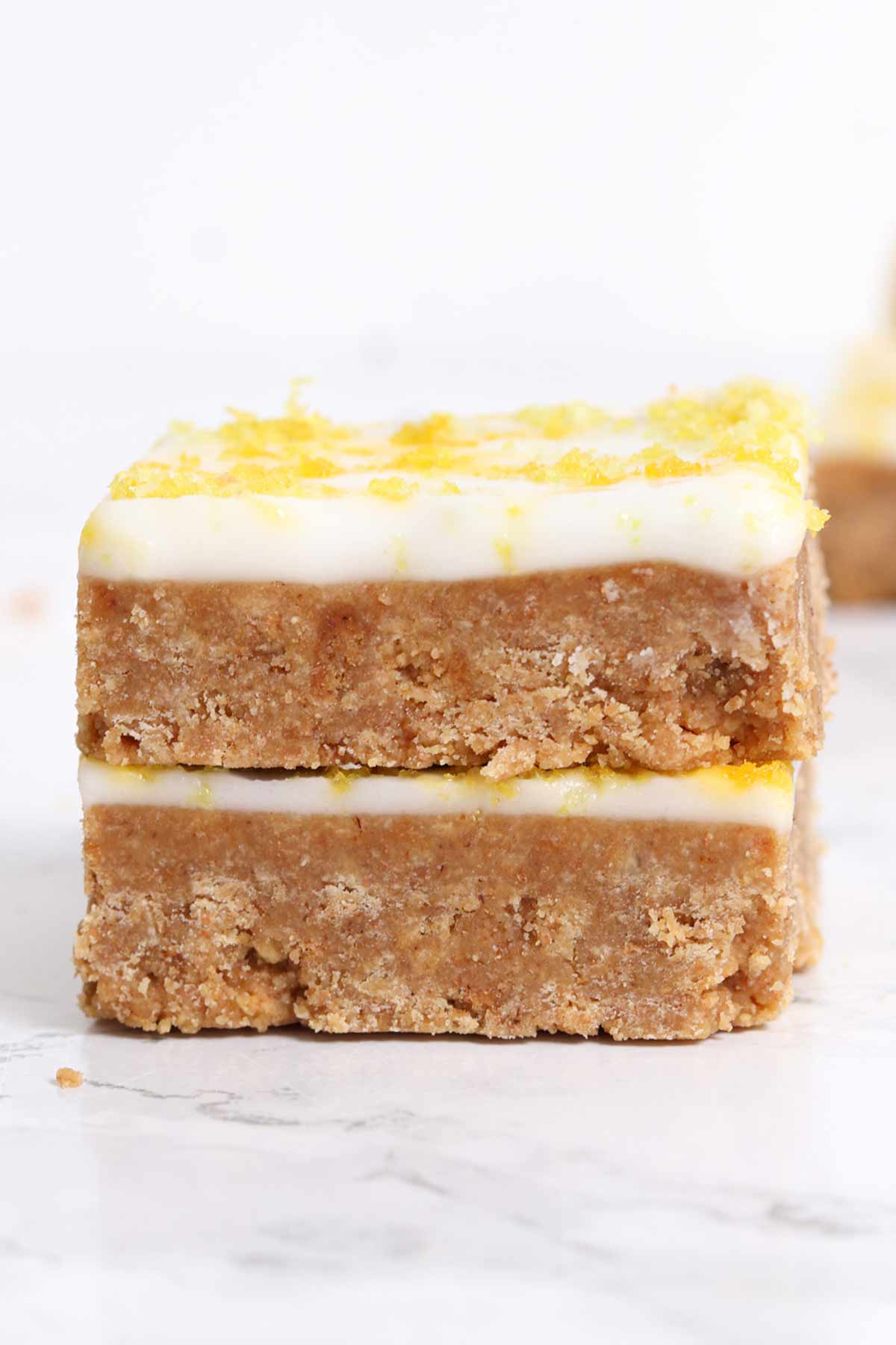 stack of 2 squares of no bake lemon biscuit slice
